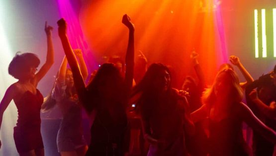 Light Up the Sound Night Event Nightclub dance party with colorful lighting and energetic crowd.
