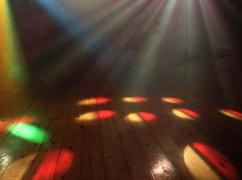 Light Up the Sound Dance Floor Colorful dance floor with vibrant lighting effects and reflections.